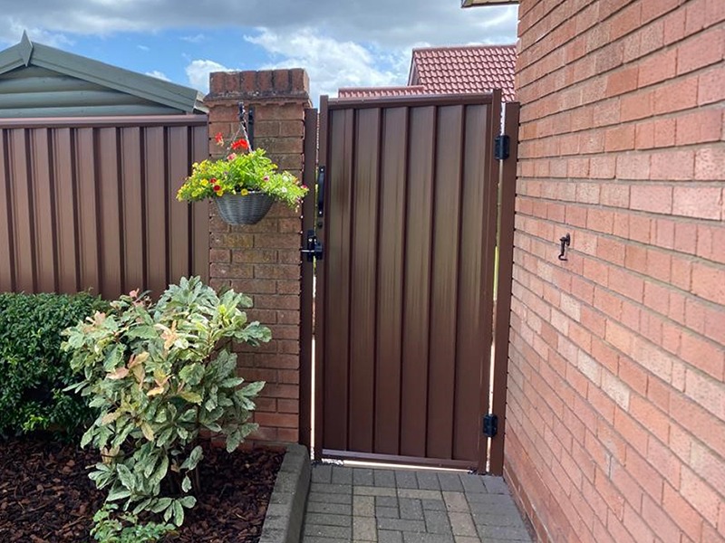 ColourFence Gate — timber-effect steel garden gate with climbing roses